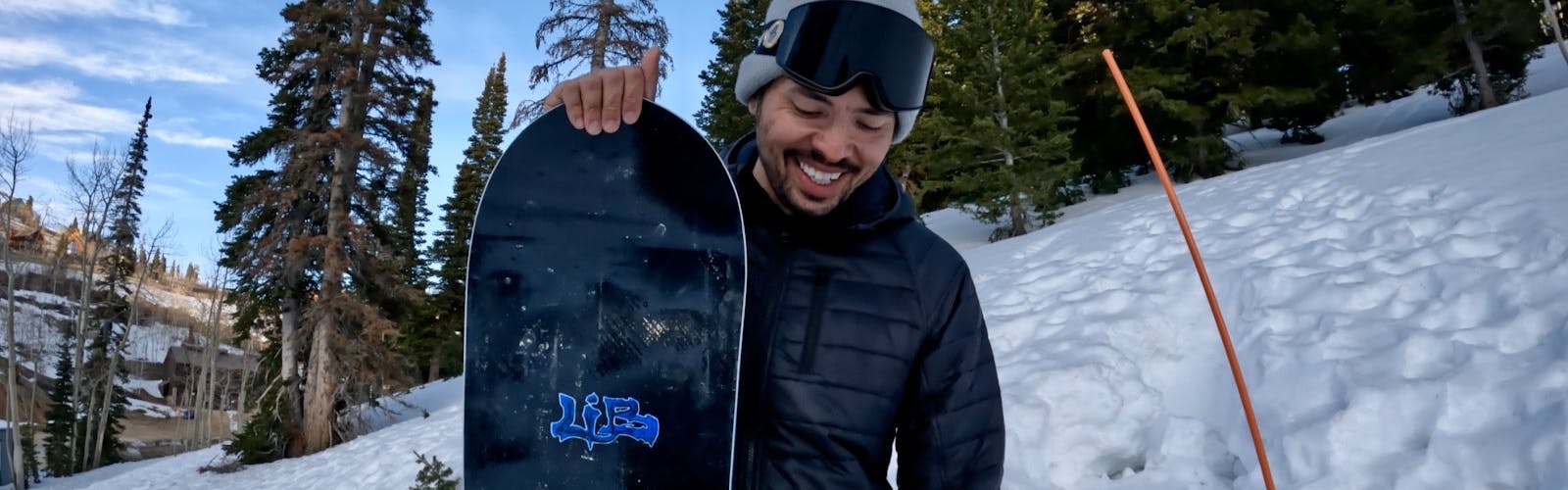 Snowboard Expert Yuri Czmola standing with the 2023 Lib Tech Skunk Ape snowboard