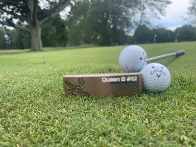 Bottom of the Bettinardi Queen B Series QB12 Putter with two golf balls sitting on it.