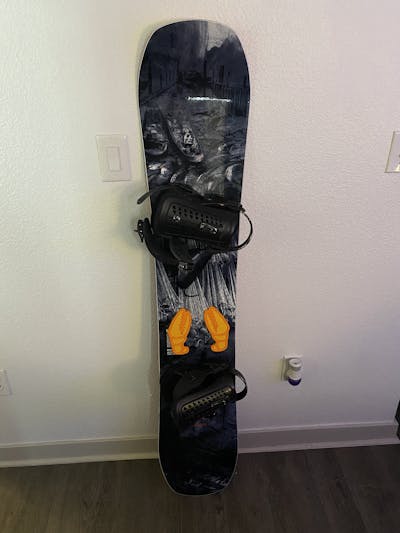 The Lib Tech Box Knife Snowboard standing against a wall.
