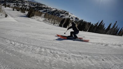Curated Ski Expert Daryl Morrison skiing a groomed slope on the 2023 Blizzard Rustler 10 skis at Powder Mountain