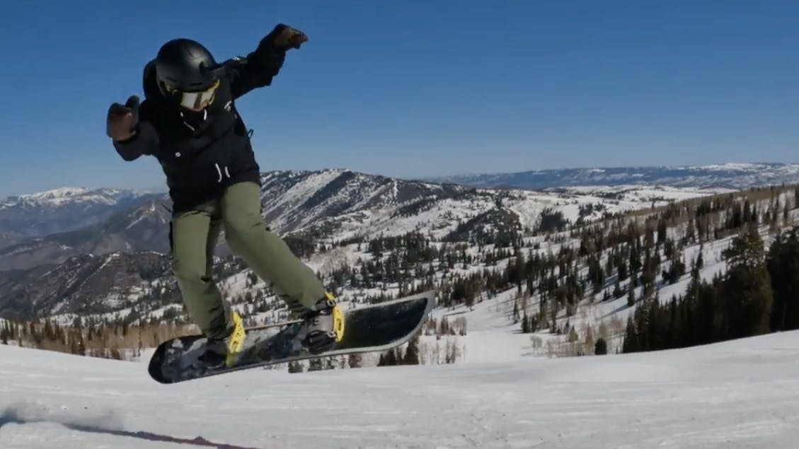 Snowboarder jumping in the air with the 2023 Burton Custom snowboard