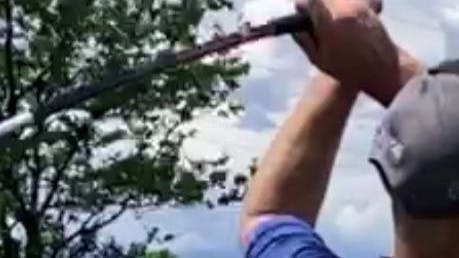 A man swinging a golf club. 