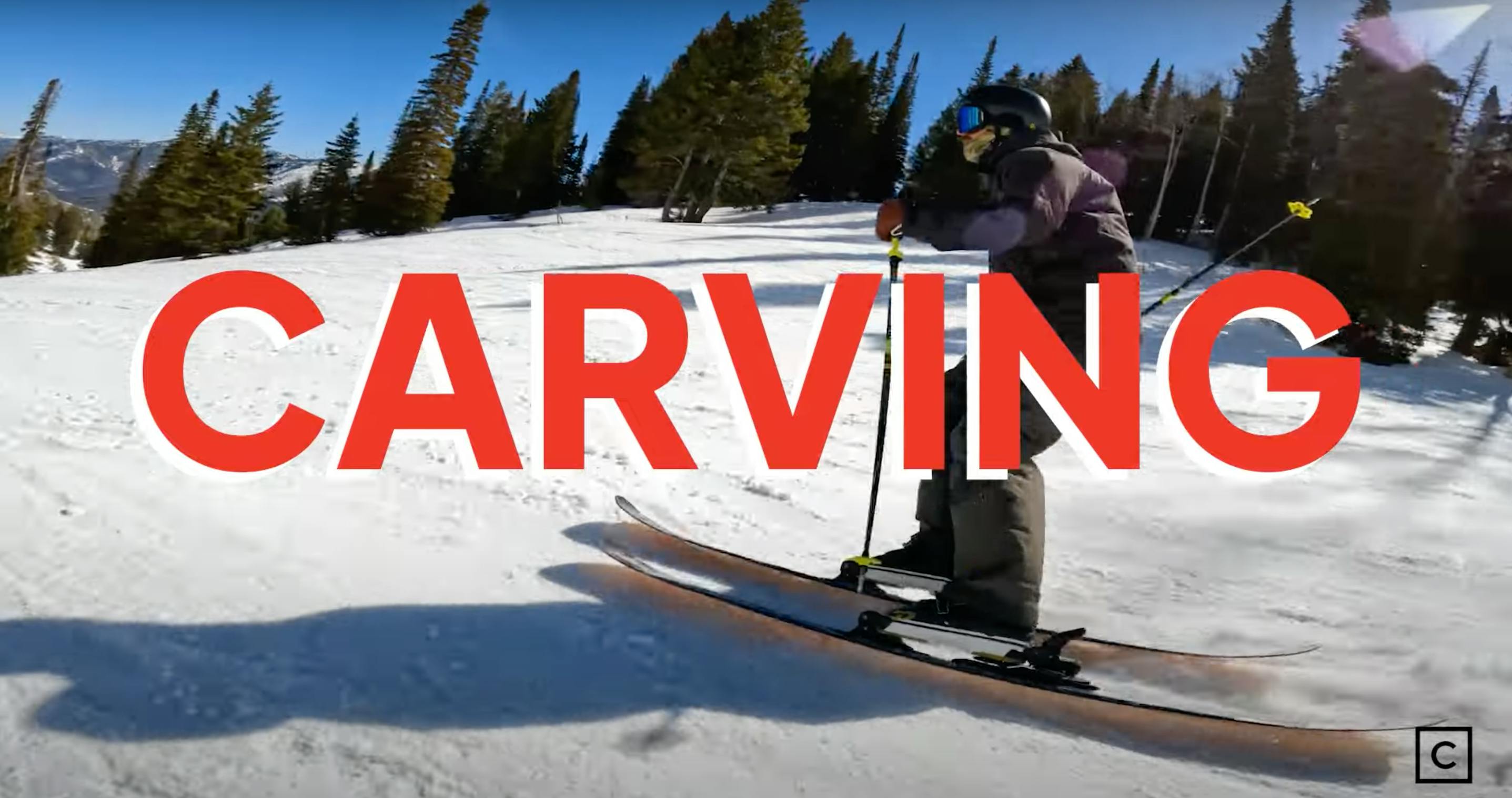 A skier turning down a slope with the word "Carving" overlayed. 