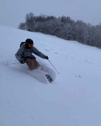 A skier turning down a snowy mountain.