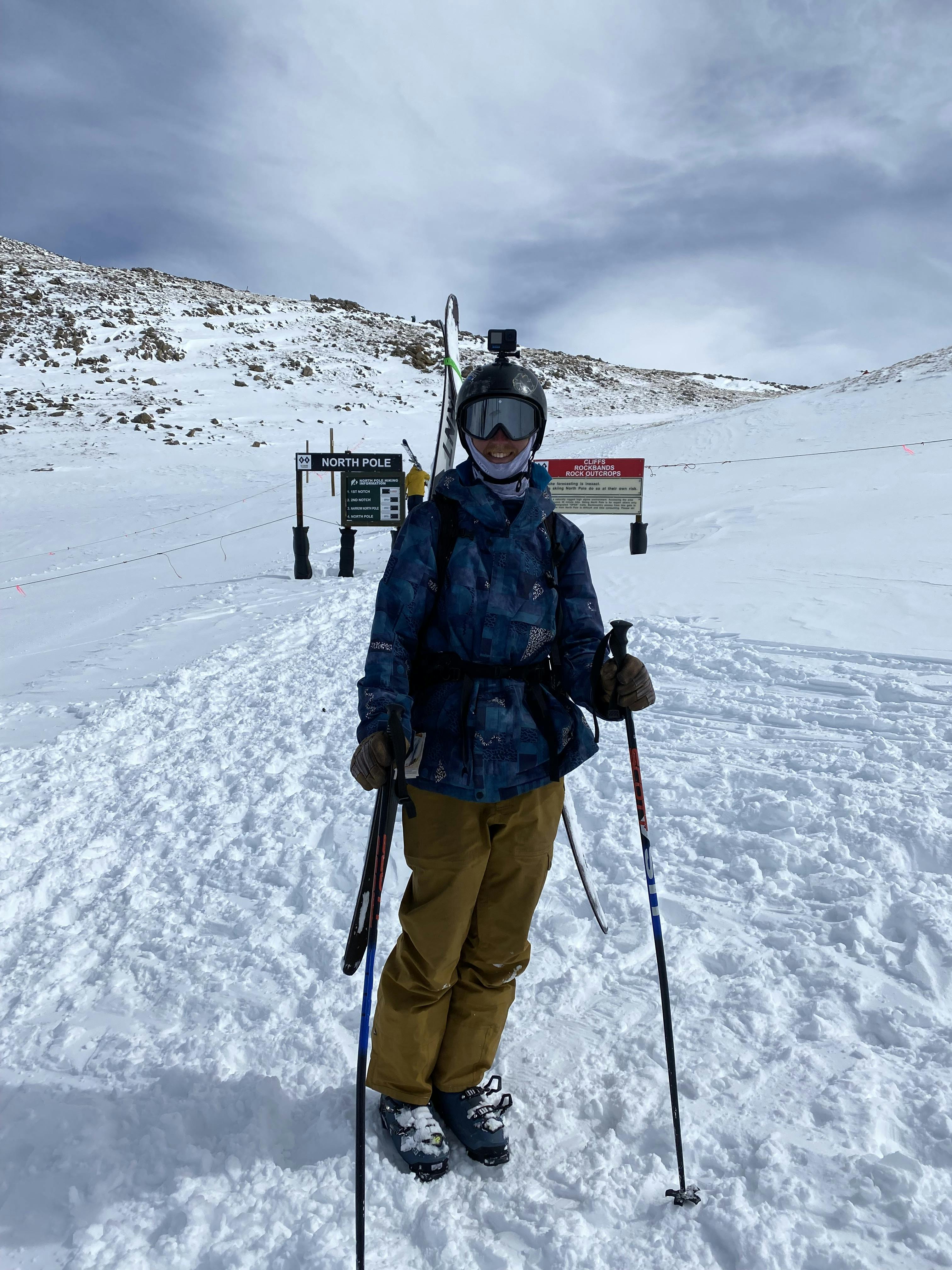A skier standing in the K2 Mindbender 100 Ski Boots · 2022 at a ski resort. 