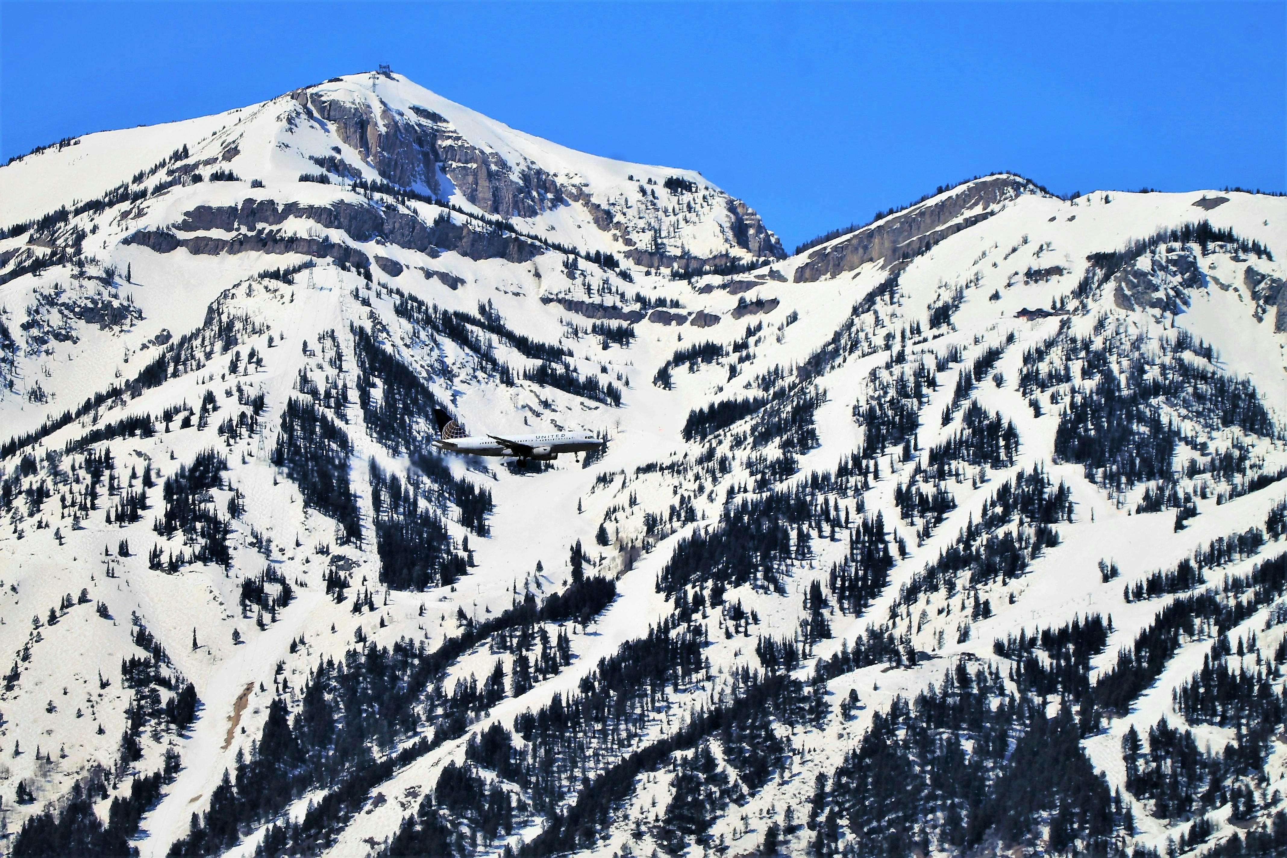 A plane descends past Jackson Hole Mountain Resort in its descent to Jackson Hole Airport.