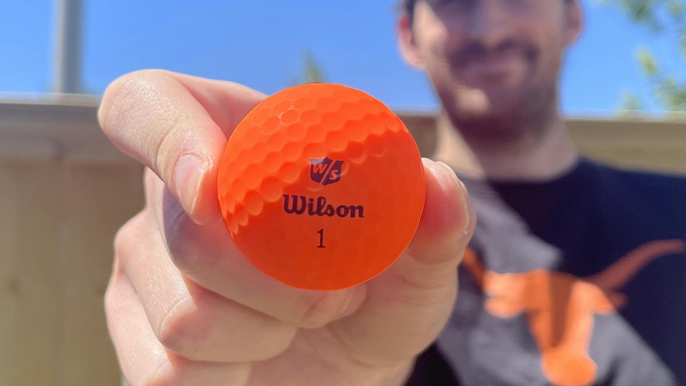 A man holding a Wilson 2022 Duo Soft Optix Golf Ball.