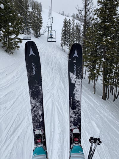 The Atomic Maverick 100 TI skis as seen from top down view on a chairlift. 