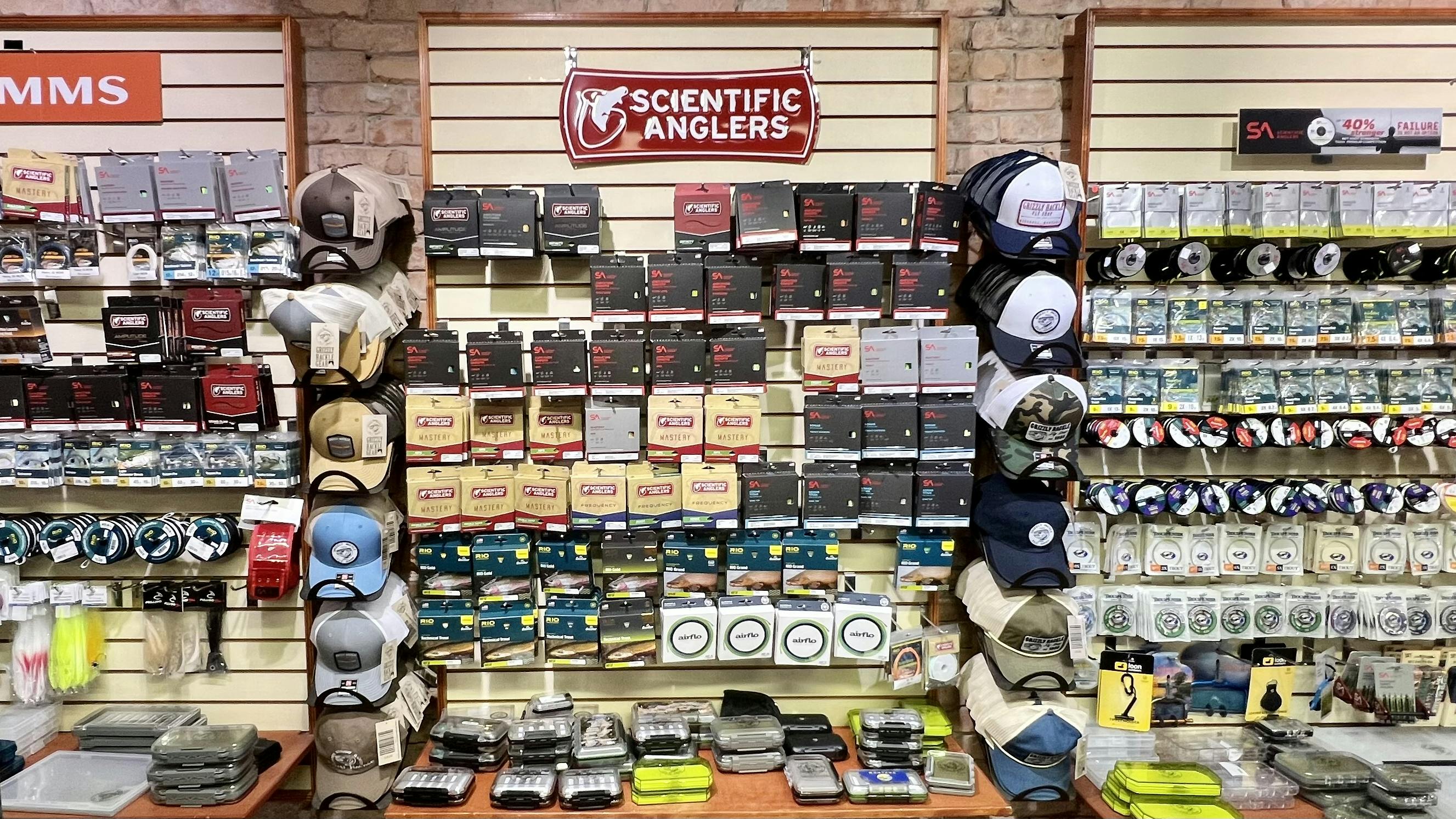 The back wall of a fly fishing shop where several different fly lines are available. 