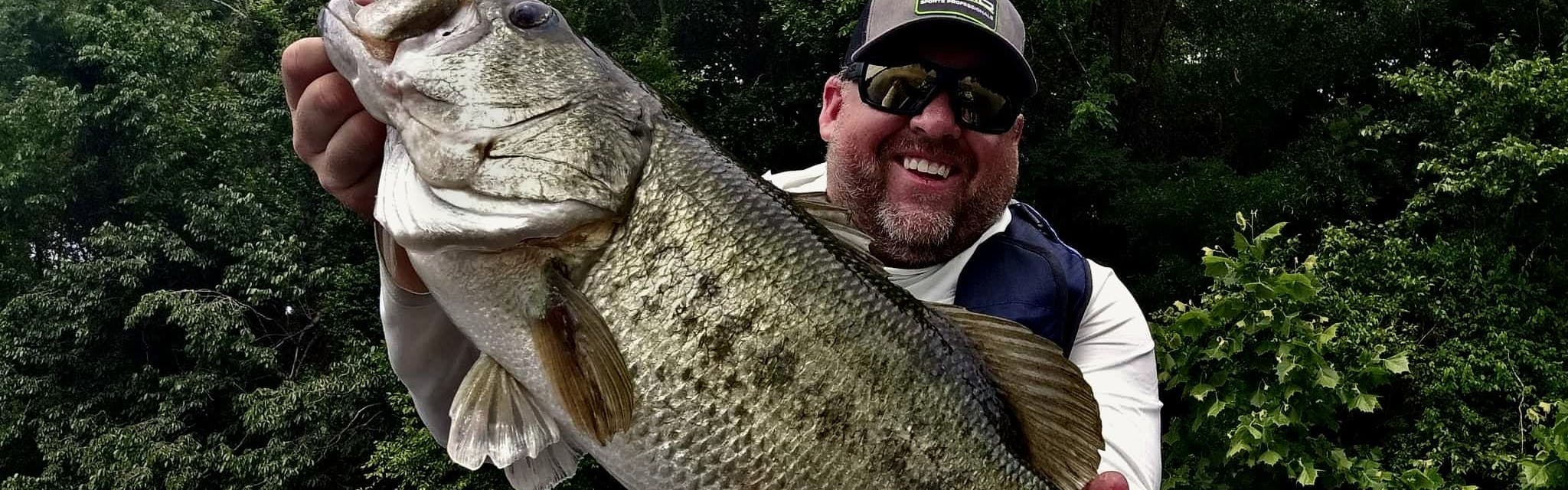 Jay Wallen with a giant bass caught on a Shimano Curado DC.