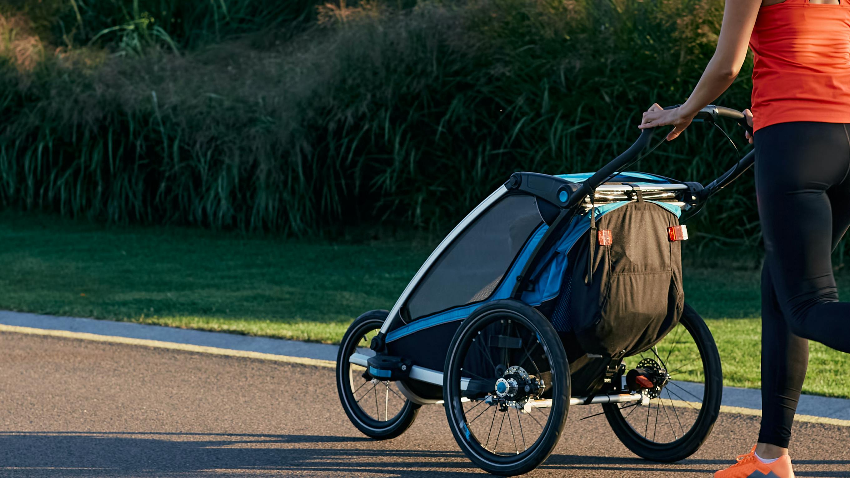 Two people walking with a baby in stroller