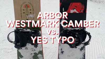 Arbor Westmark Camber snowboard standing in the snow next to the Yes. Typo snowboard with a "Arbor Westmark Camber vs. Yes Typo" graphic over the image