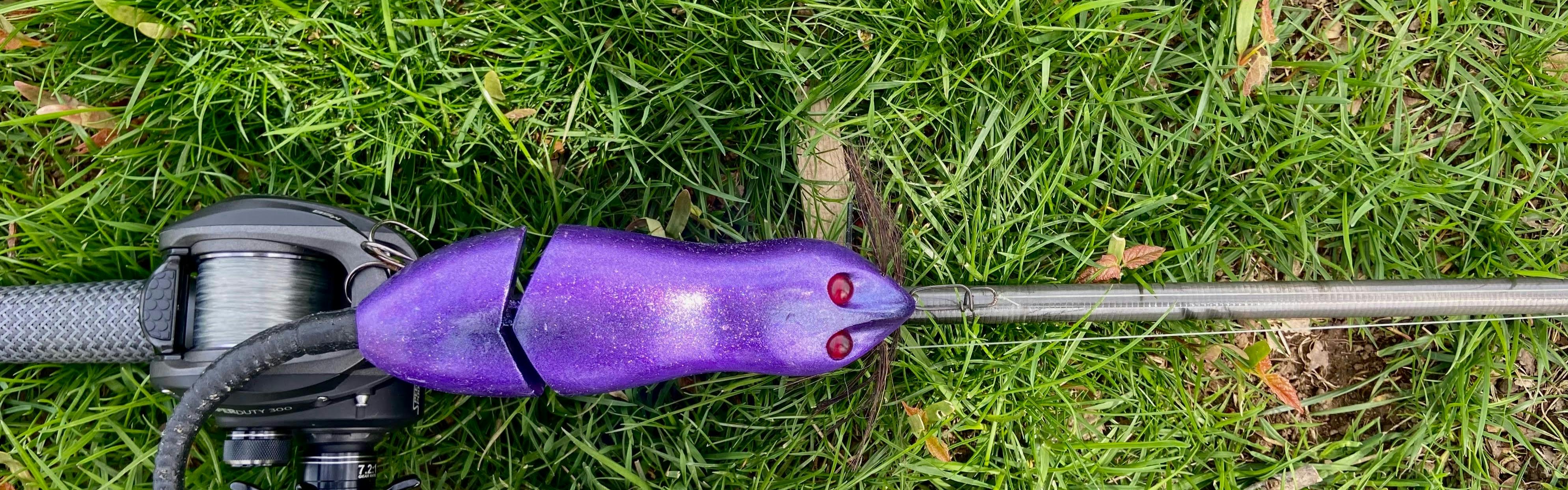 A purple lure attached to a fishing rod.