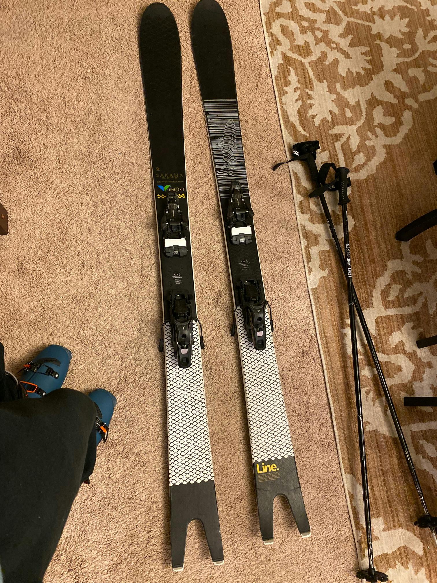 Skis with bindings laying on the floor.