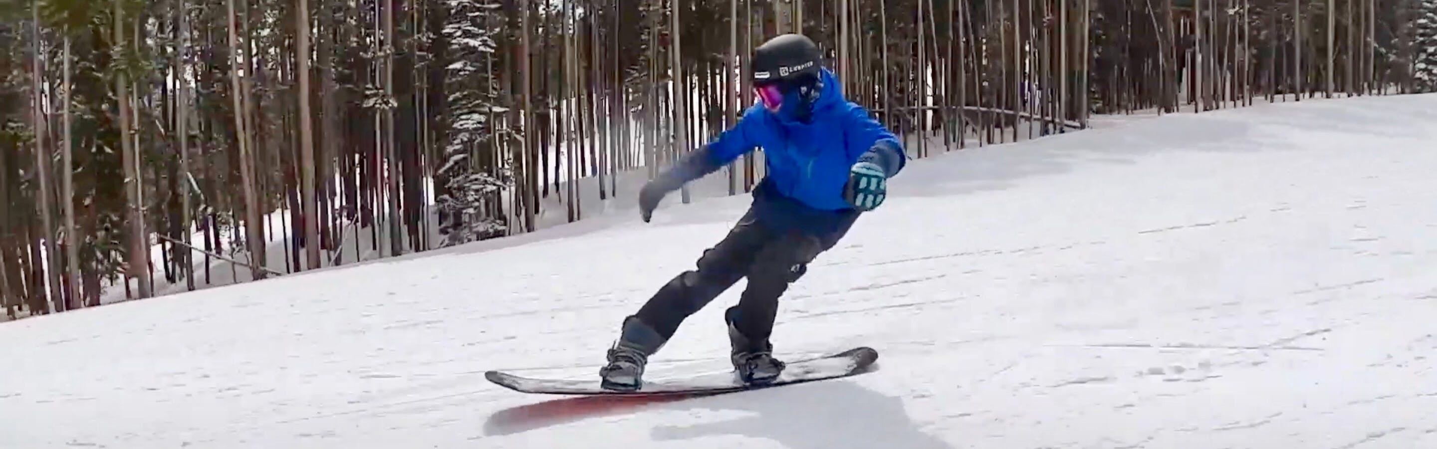 Screenshot from the YouTube video of Bobby Chadderton going downhill on the 2022 Capita Black Snowboard of Death. 