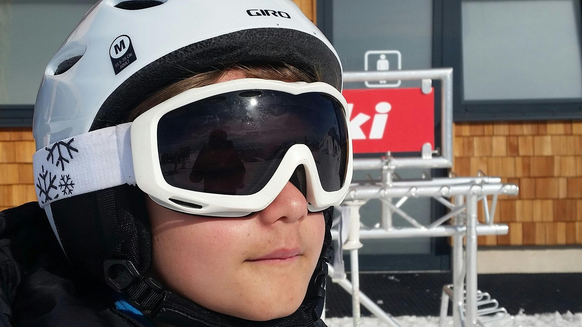 A skier wearing a helmet and goggles with a "gaper gap" showing.