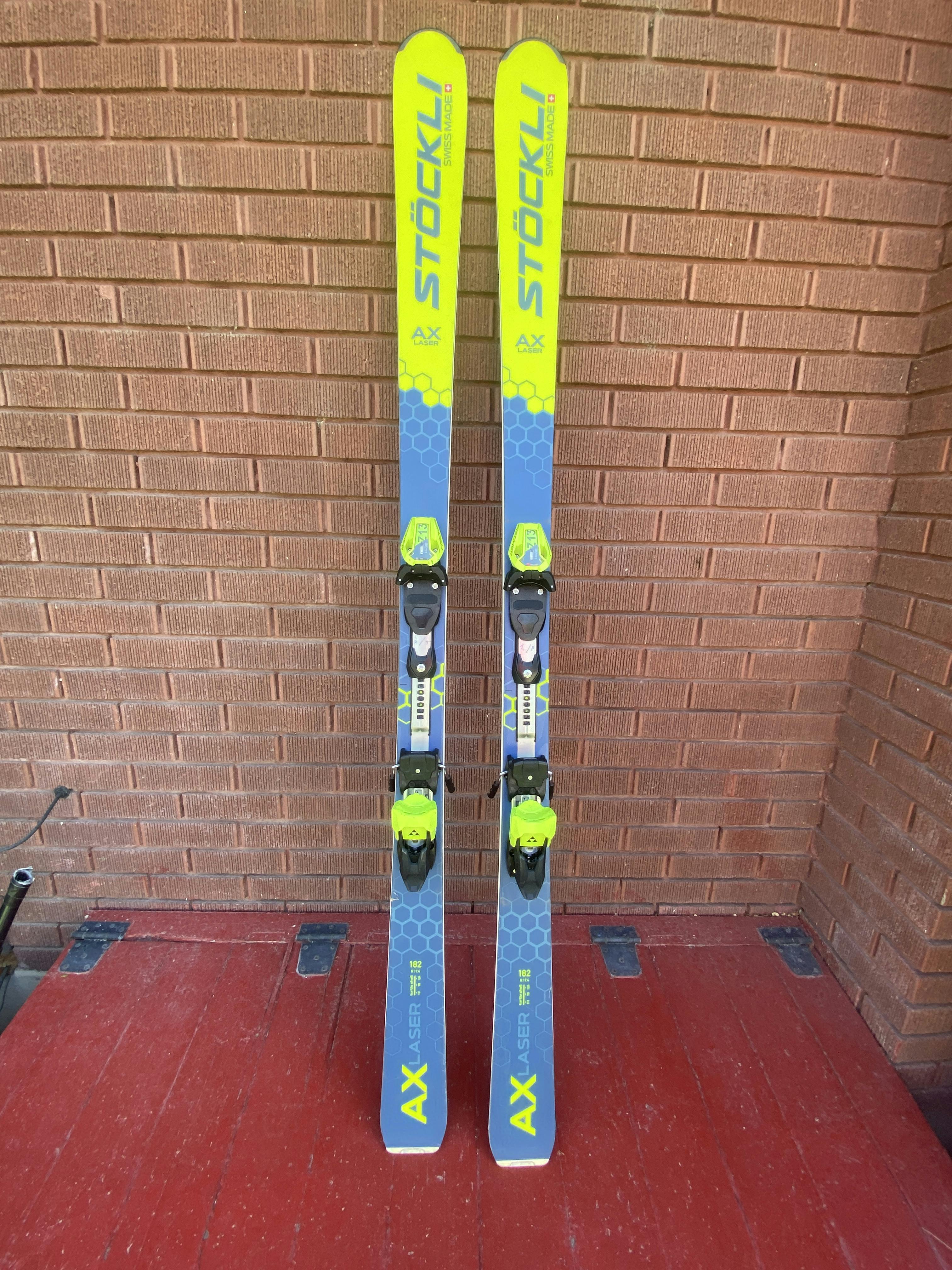 The Stockli Stockli Laser AX Skis W Dxm 13 Bindings standing next to each other. 