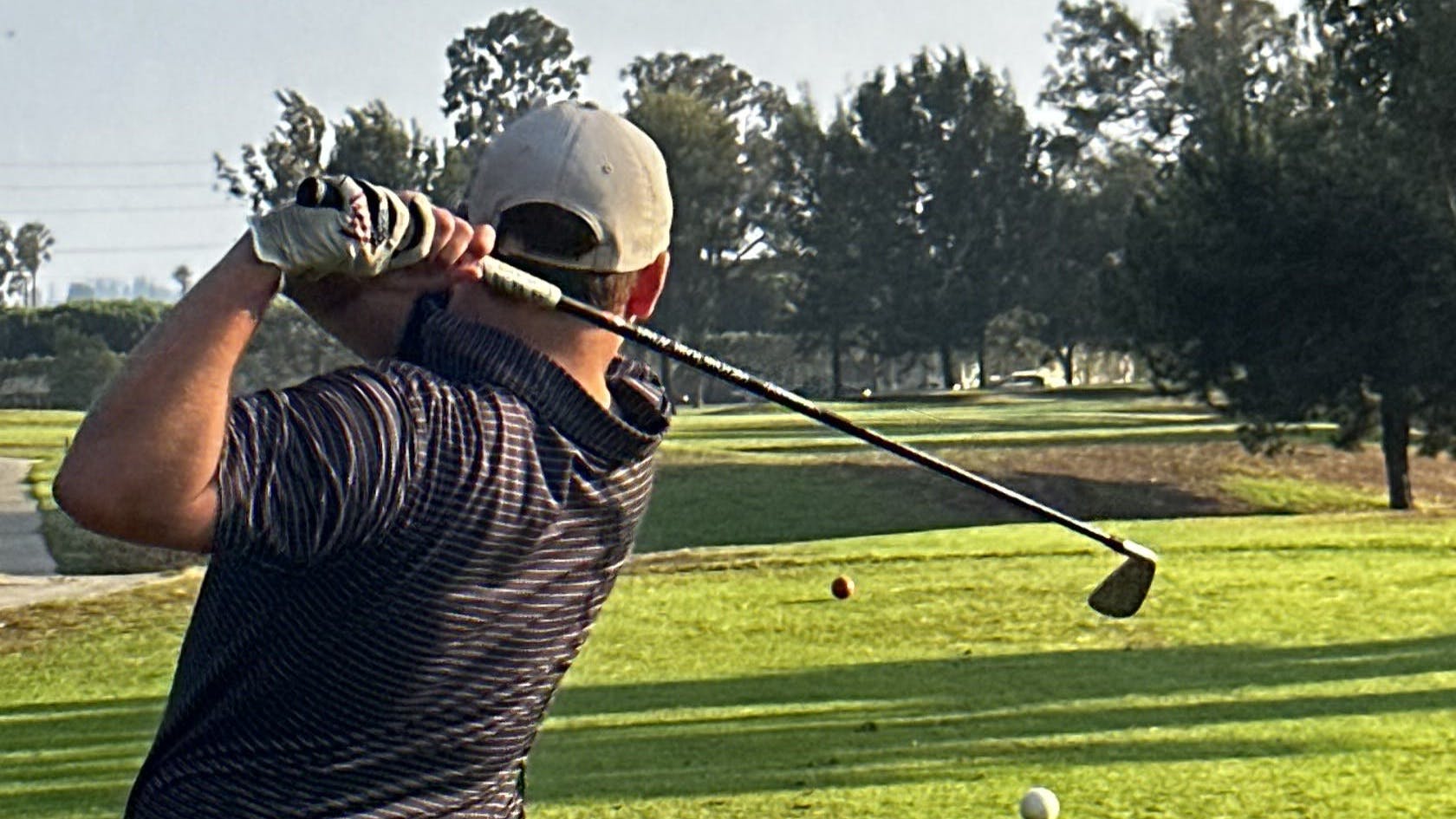 A man swinging with the  Titleist U505 Utility Iron.