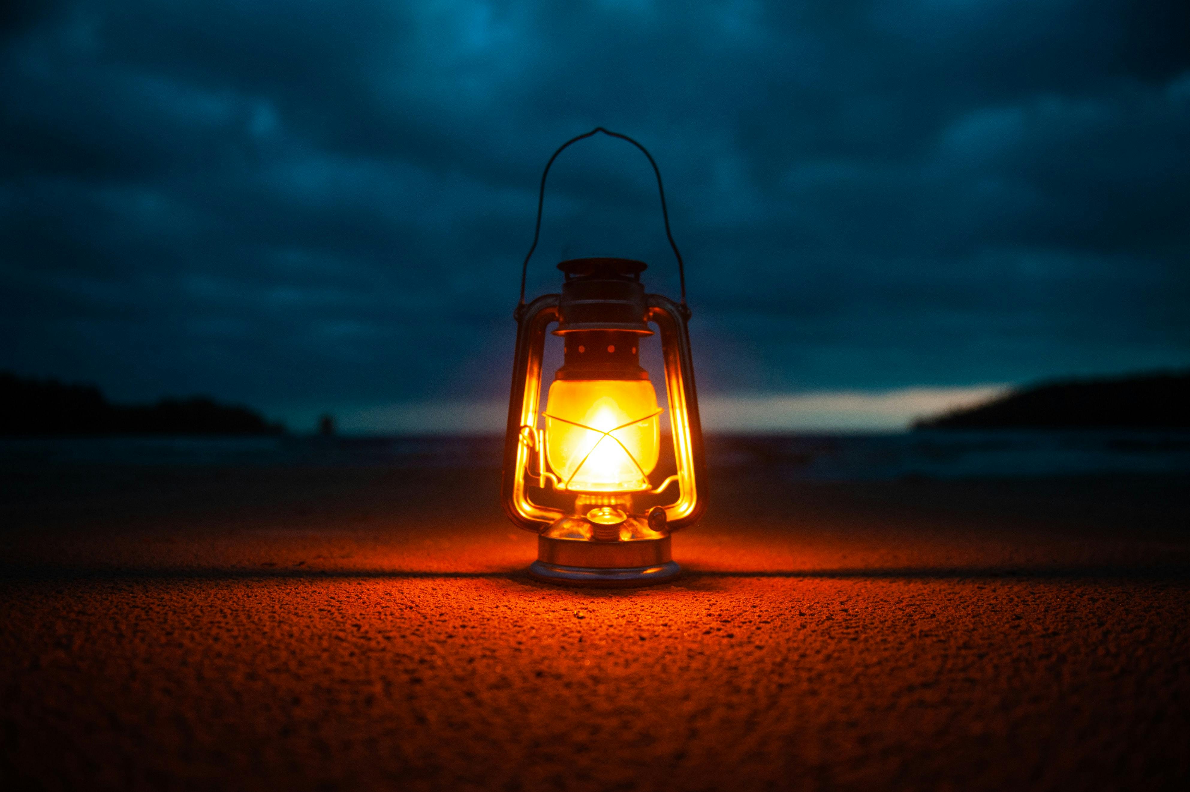 A lantern glows in the darkness