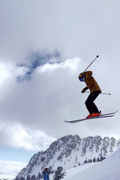 A man goes off a jump on skis.