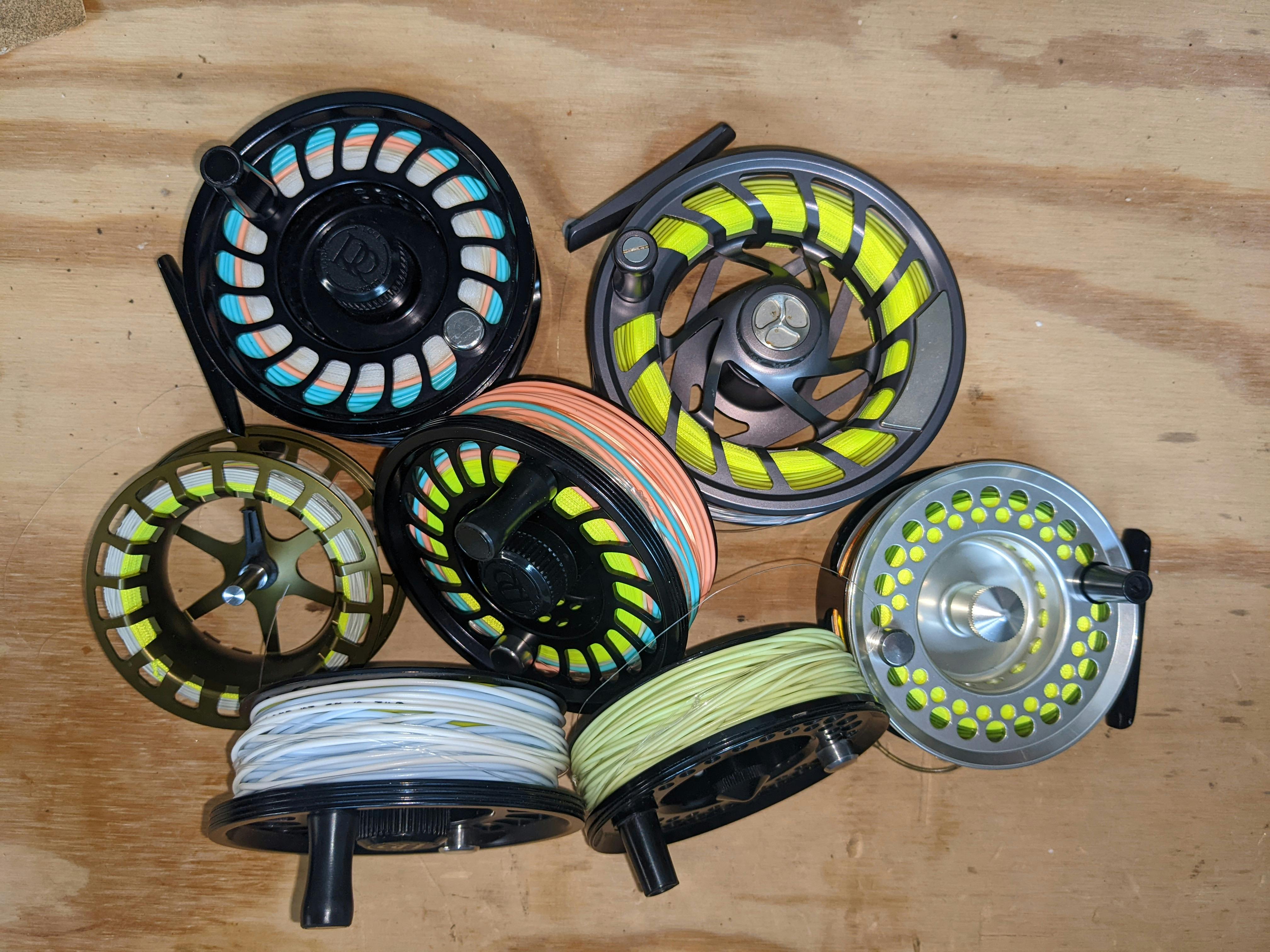 Several fly reels laying together. 