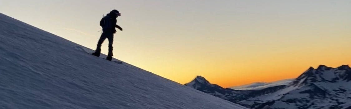 A woman snowboarding down a snowy mountain.