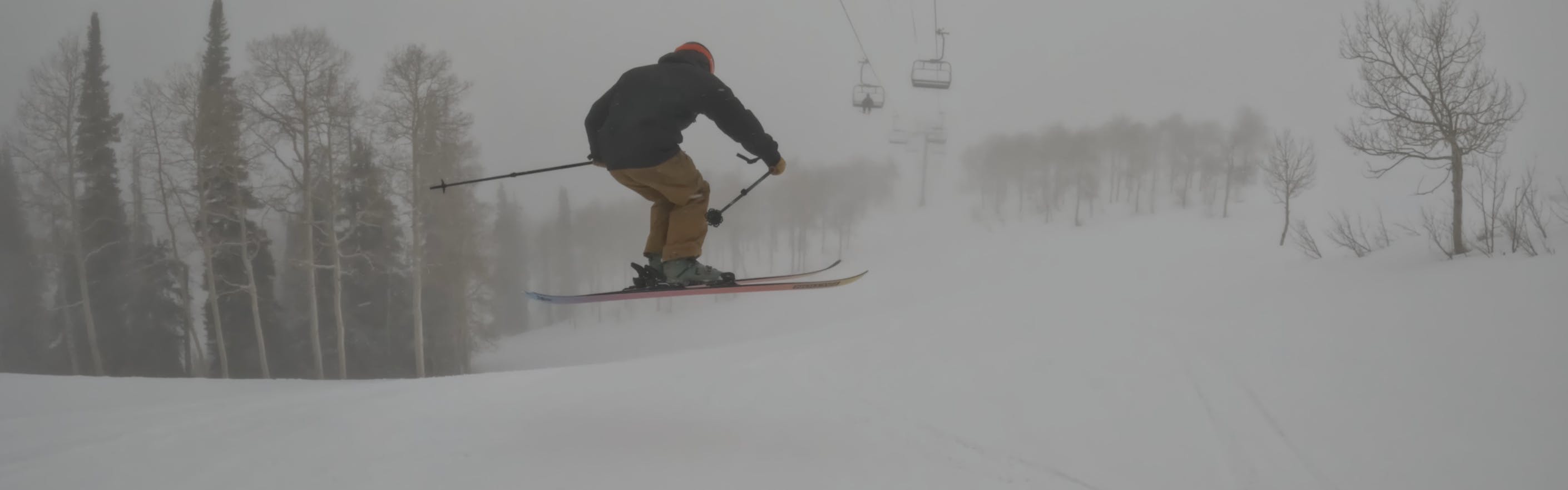 Ski Expert Theo jumping with the 2023 Faction Prodigy 2.0 skis in foggy conditions