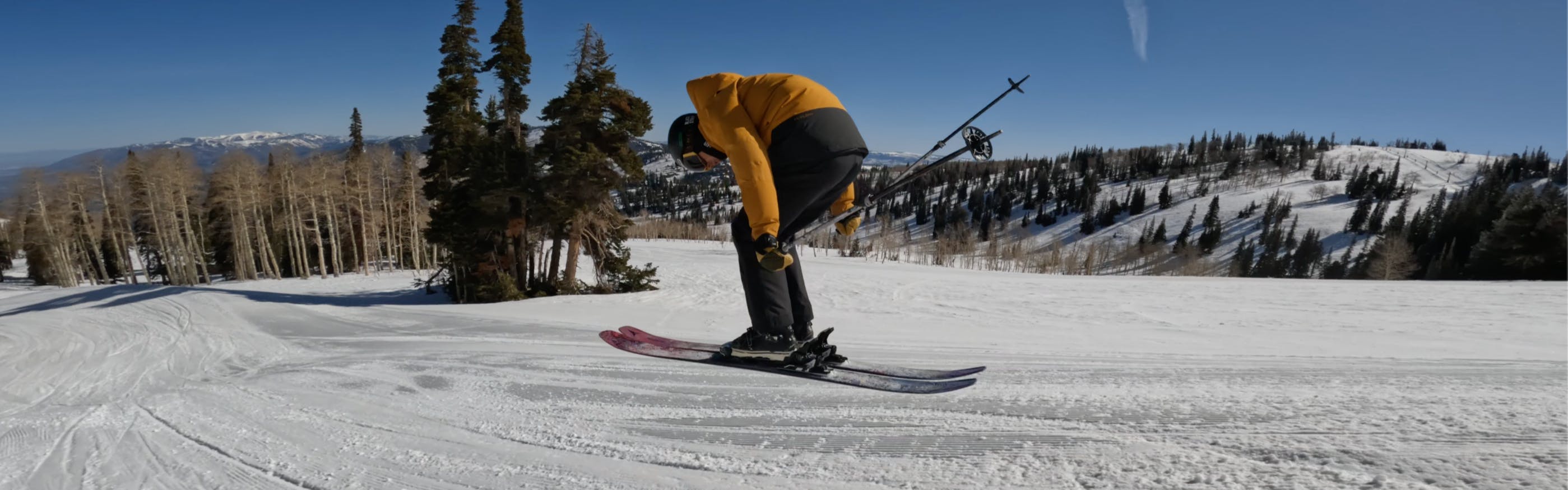 A skier doing a jump on the 2023 Atomic Bent Chetler 110 Skis.