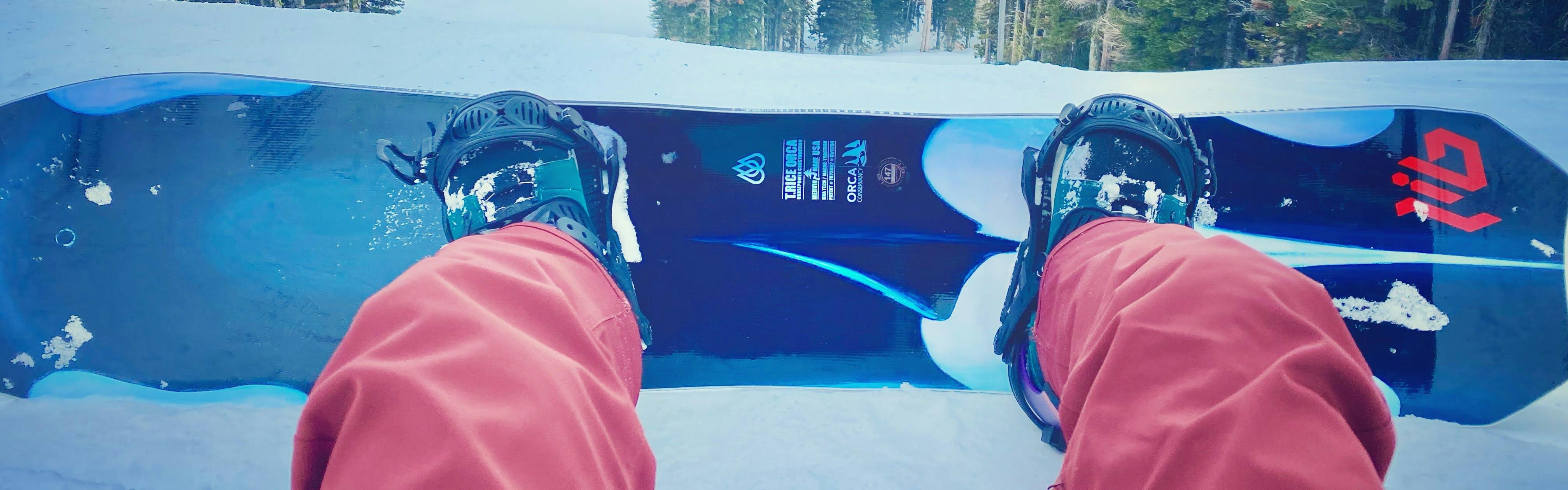 Top down view of the Lib tech Orca Snowboard on a mountain.