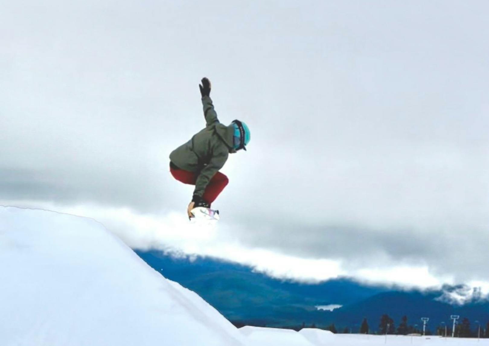 A snowboarder jumping off a jump. 
