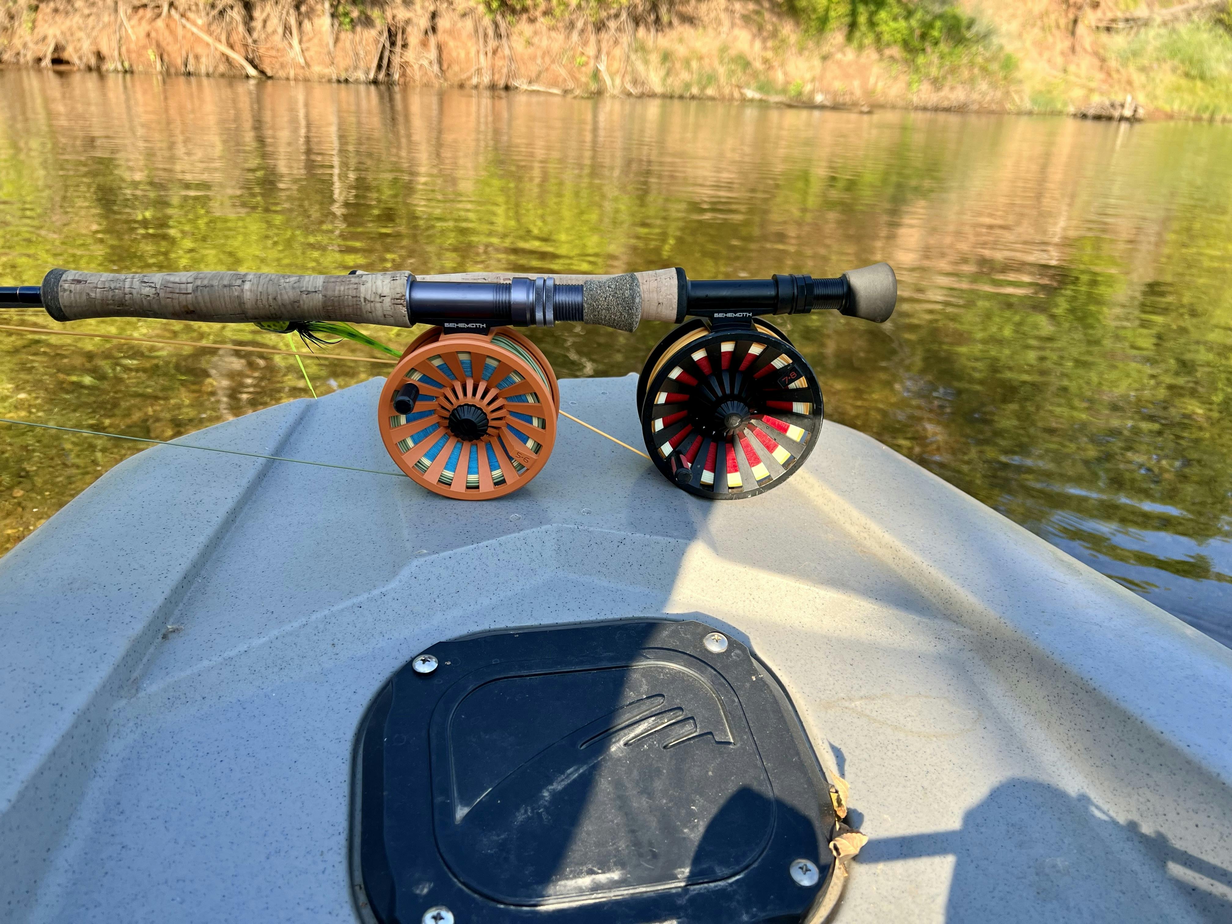 Two Redington Behemoth Series Fly Reels on the tip of a boat. 