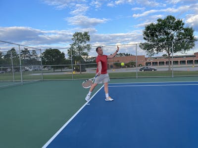 A man on a tennis court uses the Babolat Pure Strike 98 16x19 Racquet.