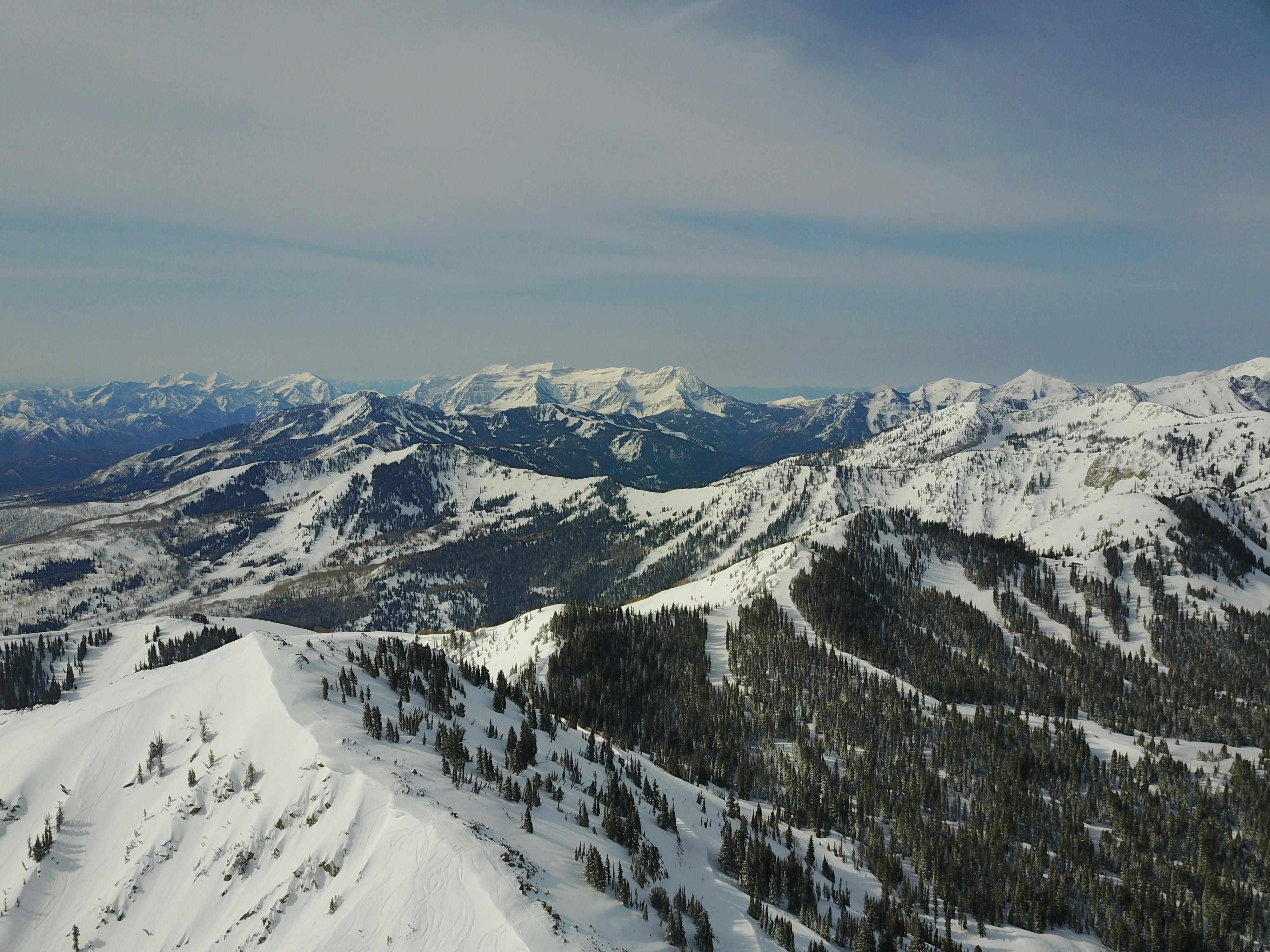 Aerial view of several snowy peaks.