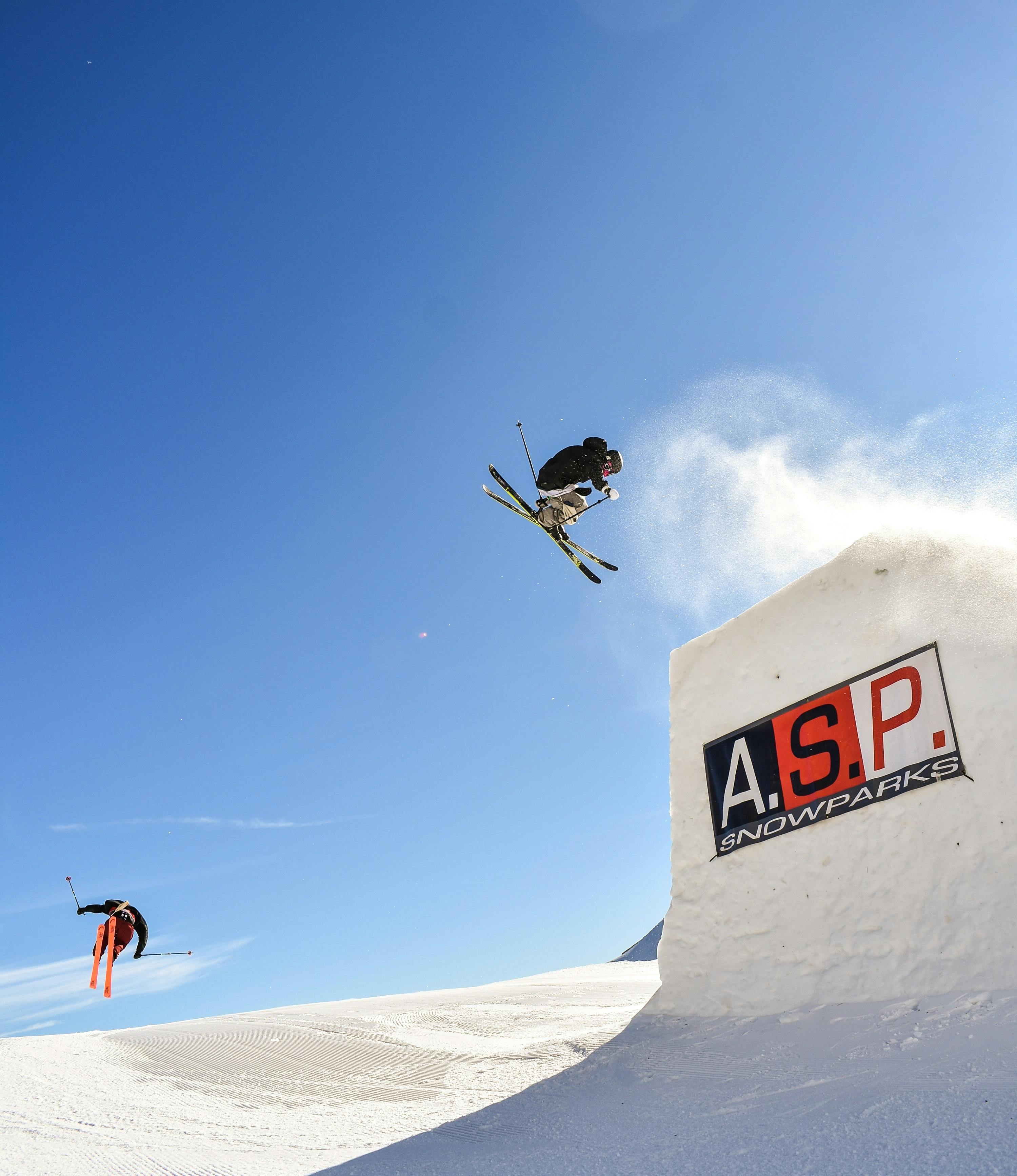 A skier jumps backward off a jump.