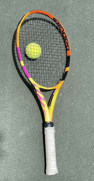 Full Babolat Pure Aero Rafa 100 Racquet and tennis ball.