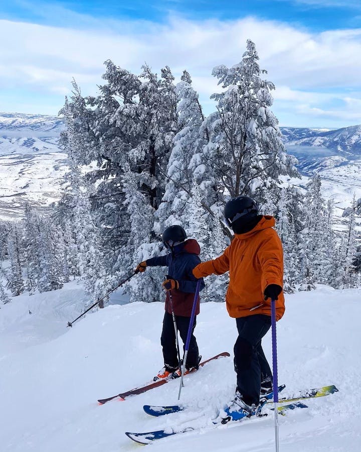 Two skiers on a mountain, one on the  Blizzard Cochise 106 Skis · 2021.