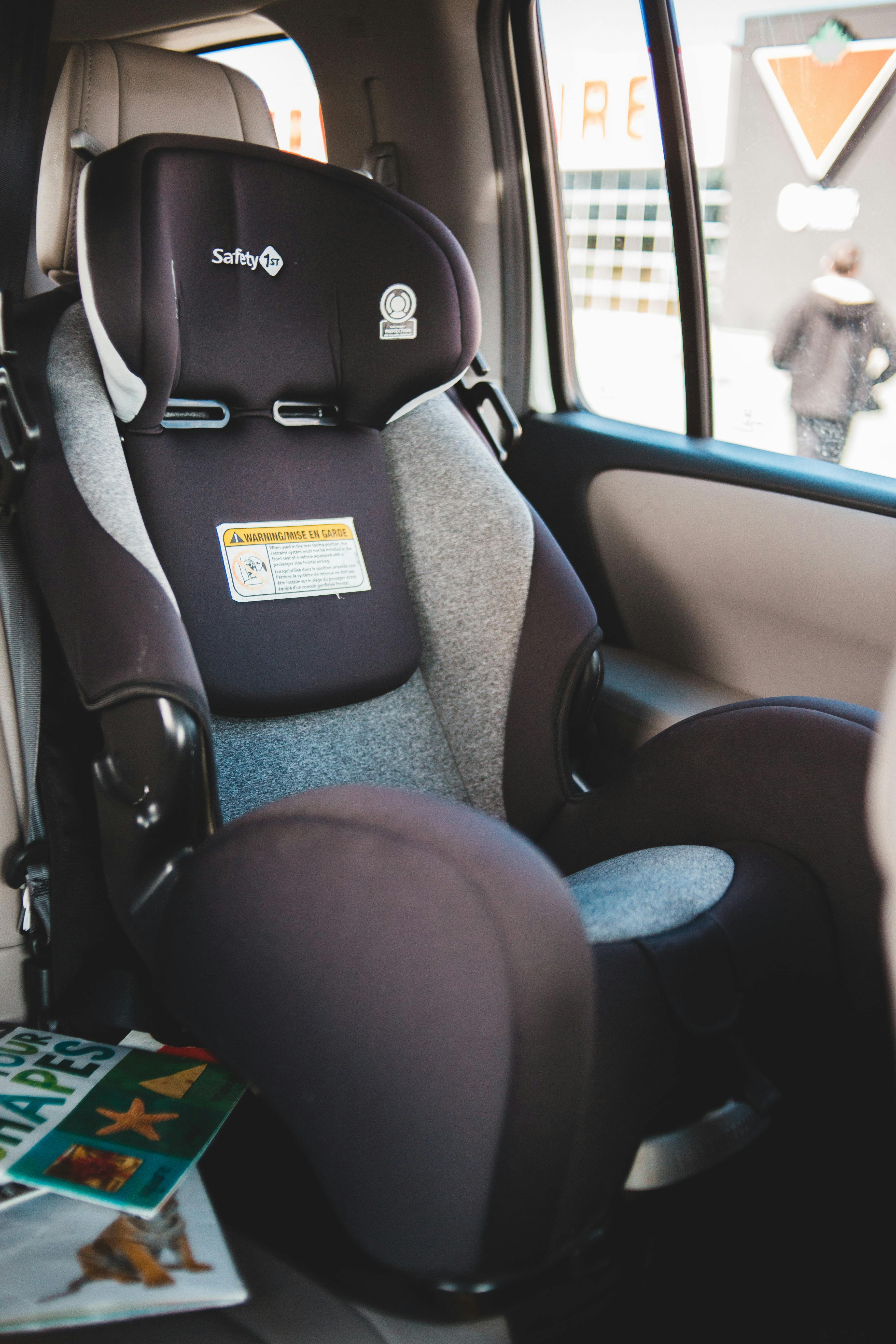 An empty baby car seat in a car.