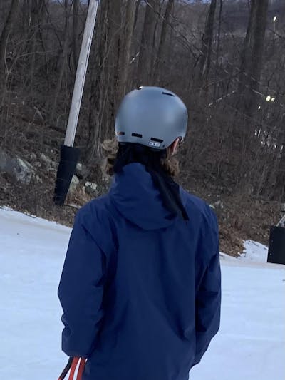 Back view of someone at a ski resort wearing the Giro Ledge MIPS Helmet.