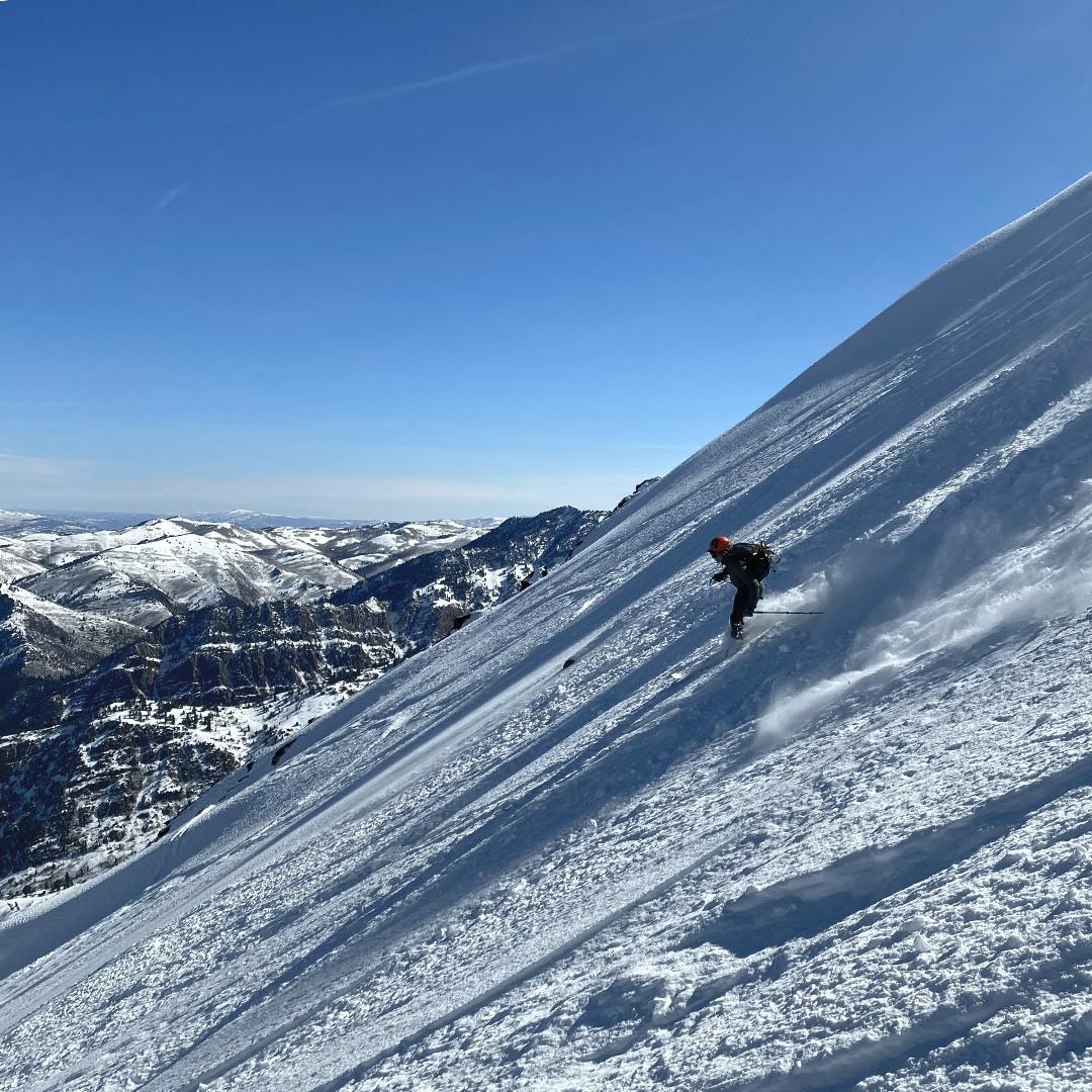 A skier skiing down a mountain. 