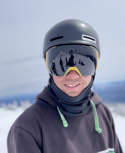 A skier wearing a Smith Maze MIPS helmet. 