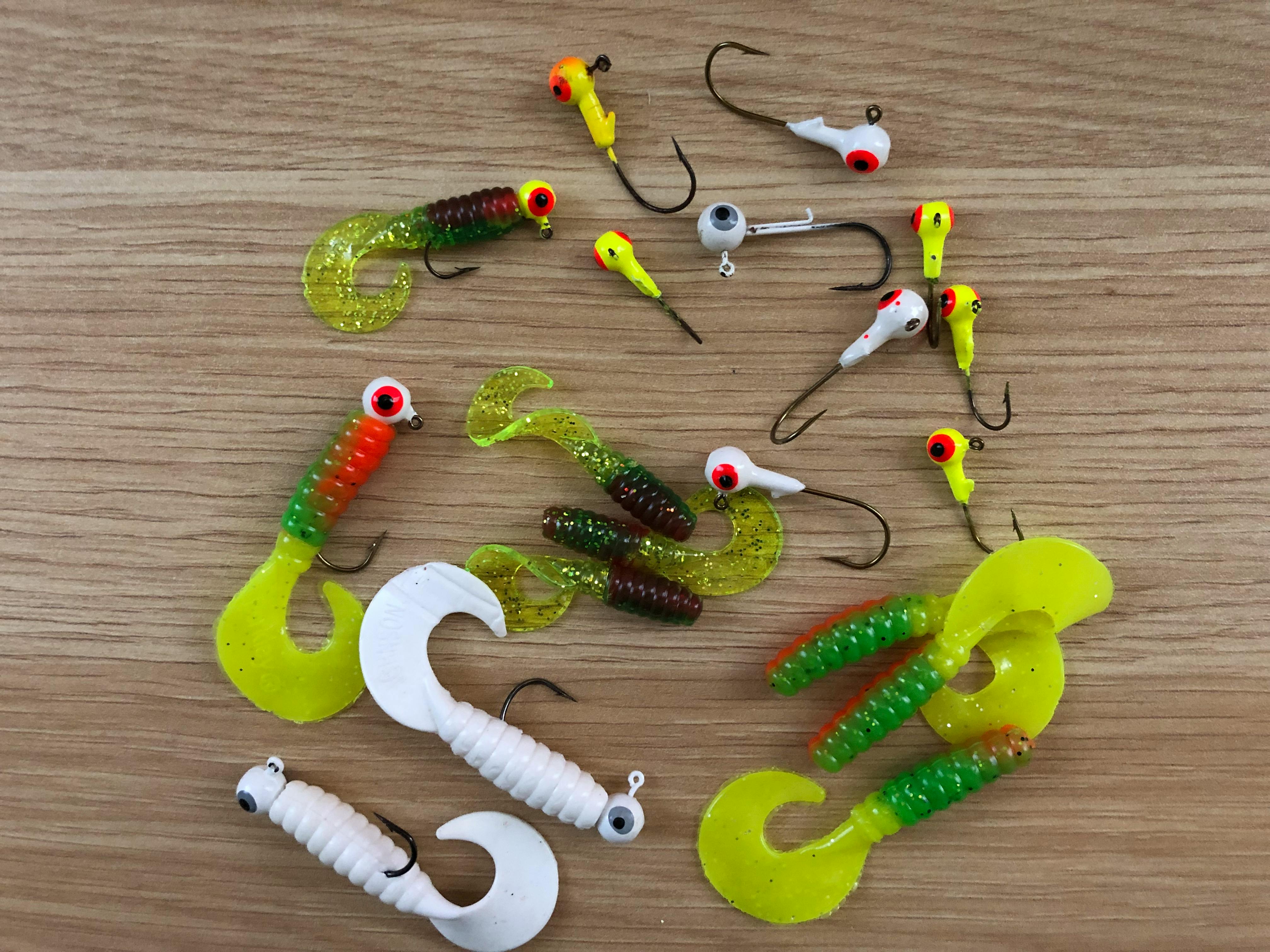 Fishing on a table. Some are white and some are green and yellow.