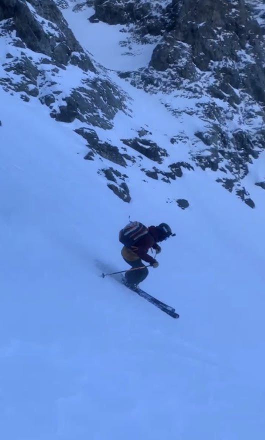 A man turning down a ski run. 