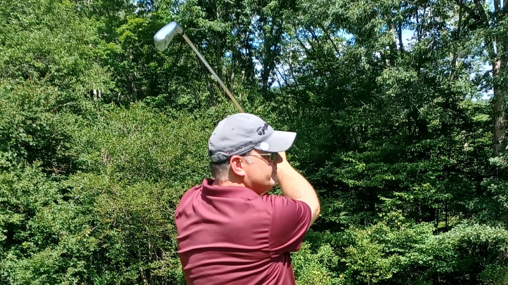 A man golfing with the Cleveland UHX Iron. 