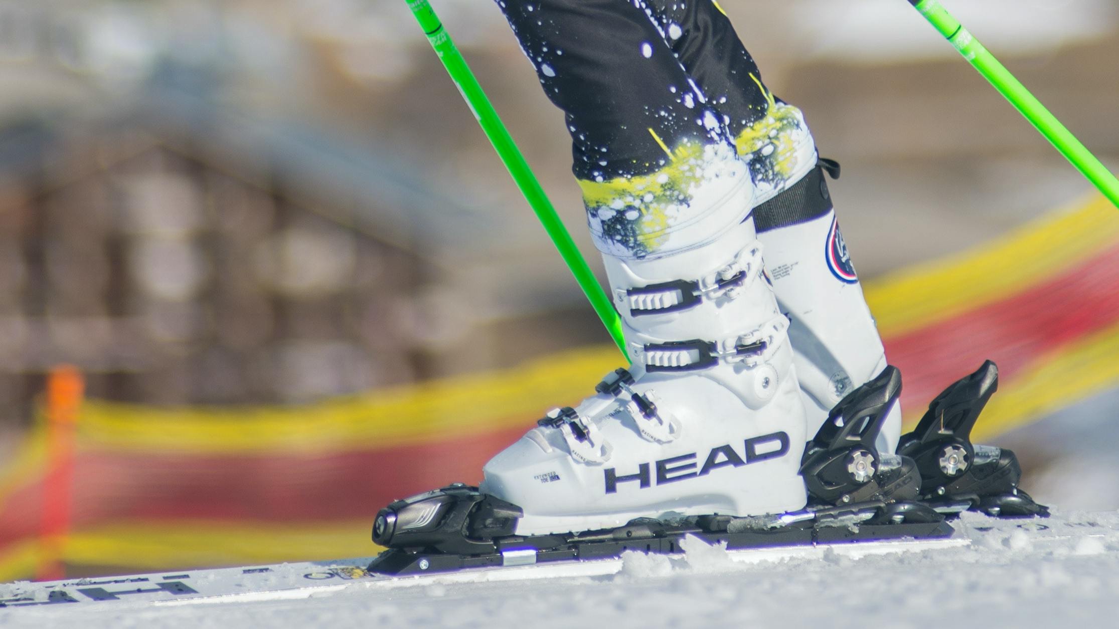 A pair of ski boots clipped into skis on the snow. 