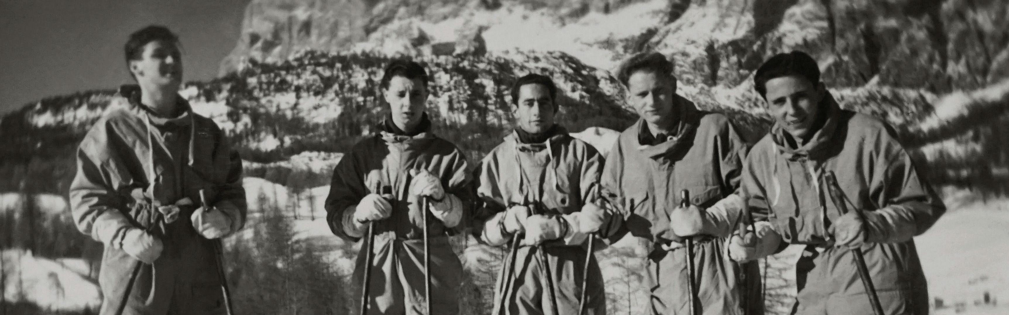A black and white photo of a group of skiers.