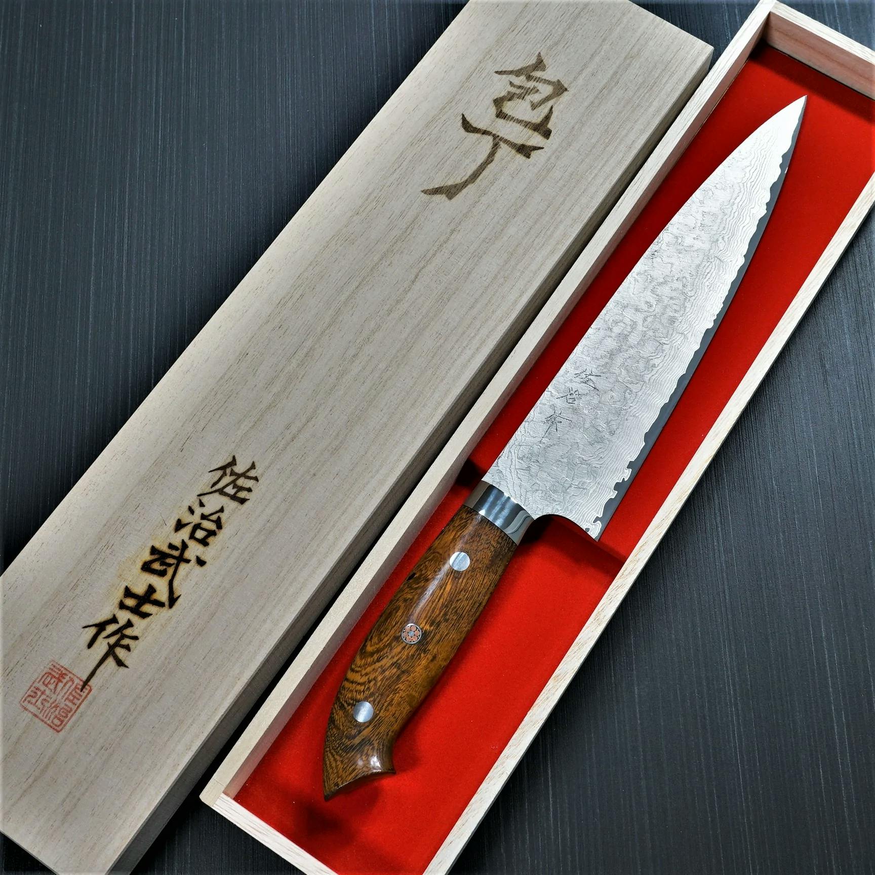 Takeshi Saji logo on a knife.