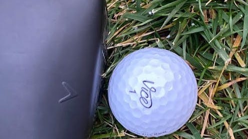 The Stix + Vice Drive Golf Ball next to a golf ball.