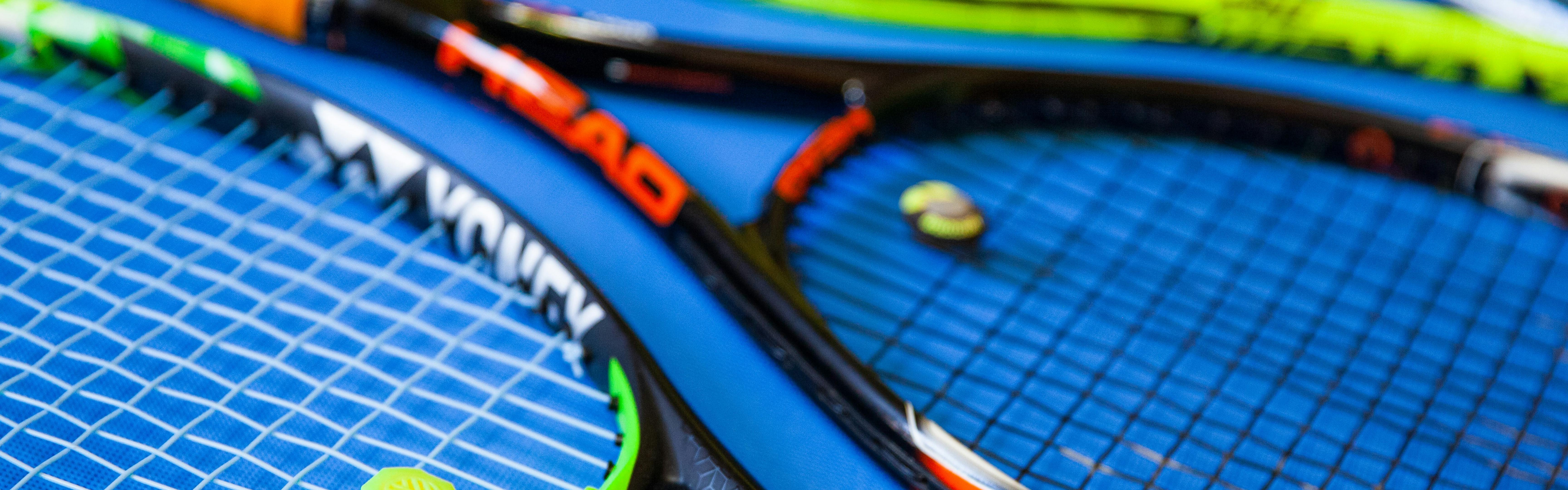Several tennis racquets in a row.