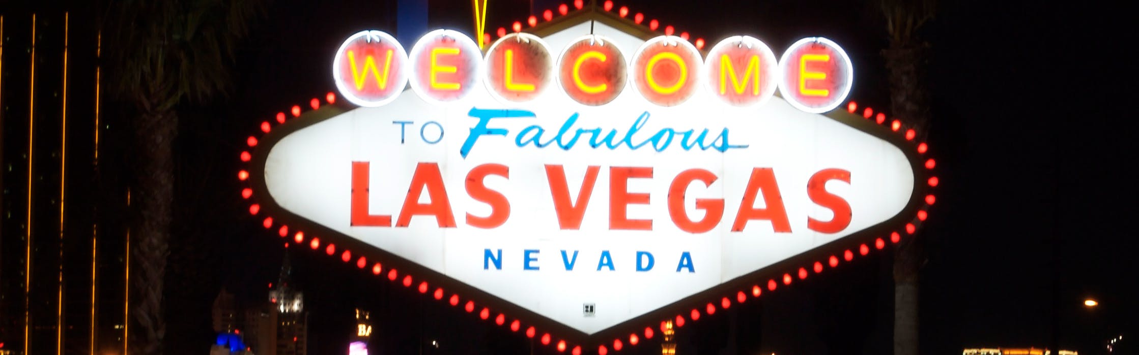 A lit up sign that reads "Welcome to Fabulous Las Vegas, Nevada". Behind the sign it is dark.