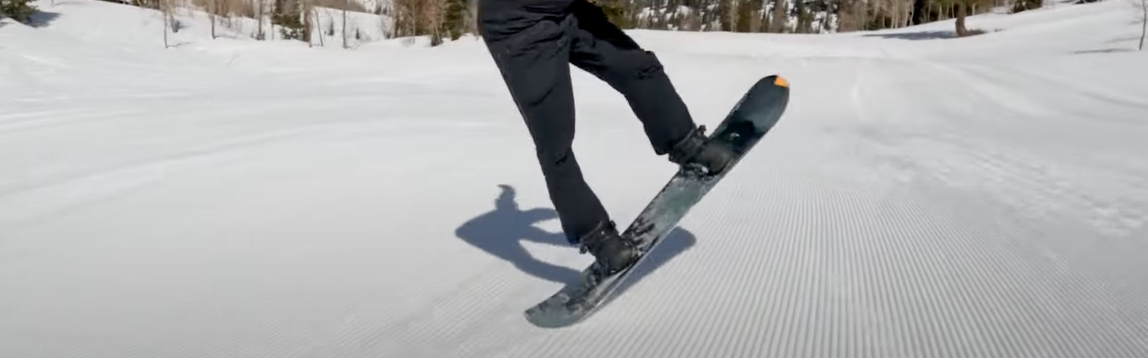 A snowboarder doing a trick. 